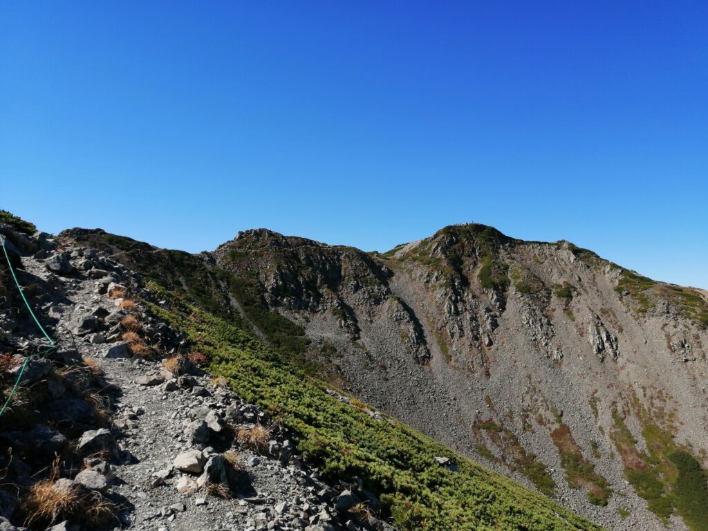 Cim de Senjogatake amb el coster en primer pla 